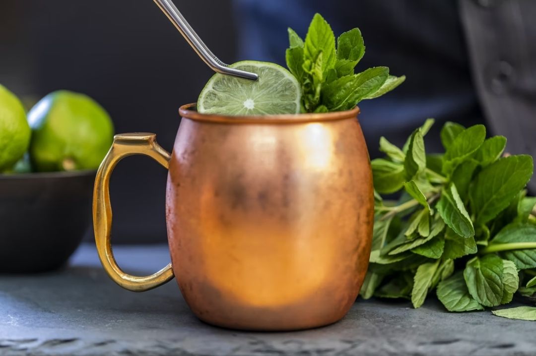 Enjoying cocktails in Copper Mugs copper mug